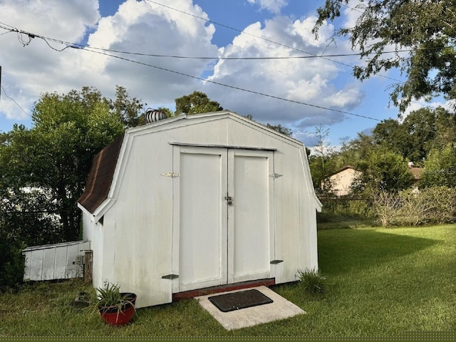 view of outbuilding with a yard