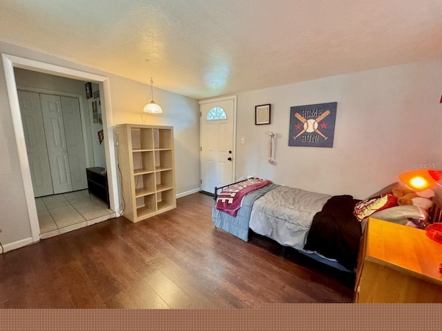 bedroom featuring a textured ceiling and hardwood / wood-style flooring