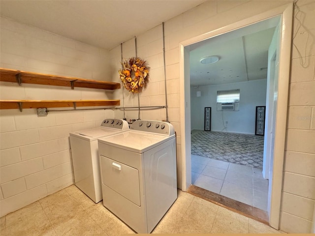 washroom with tile walls, cooling unit, and washing machine and dryer