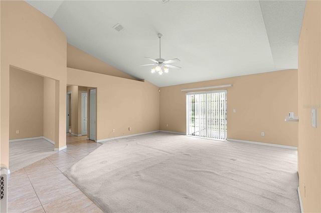 carpeted spare room with high vaulted ceiling and ceiling fan