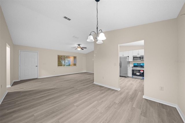 interior space featuring ceiling fan with notable chandelier, lofted ceiling, and light hardwood / wood-style floors