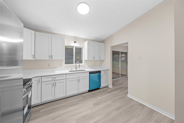 kitchen featuring light hardwood / wood-style flooring, appliances with stainless steel finishes, white cabinetry, and sink