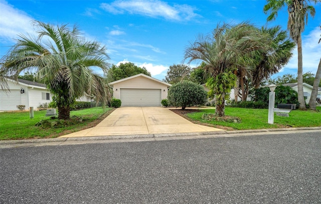 view of front facade featuring a garage, an outbuilding, and a front yard