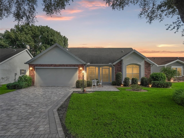 ranch-style home with a lawn and a garage