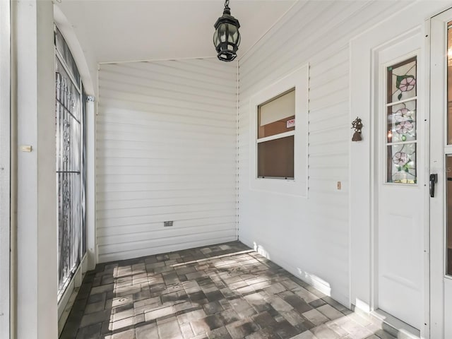 unfurnished sunroom with vaulted ceiling