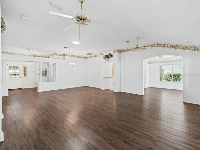 unfurnished living room with ceiling fan, lofted ceiling, and dark wood-type flooring