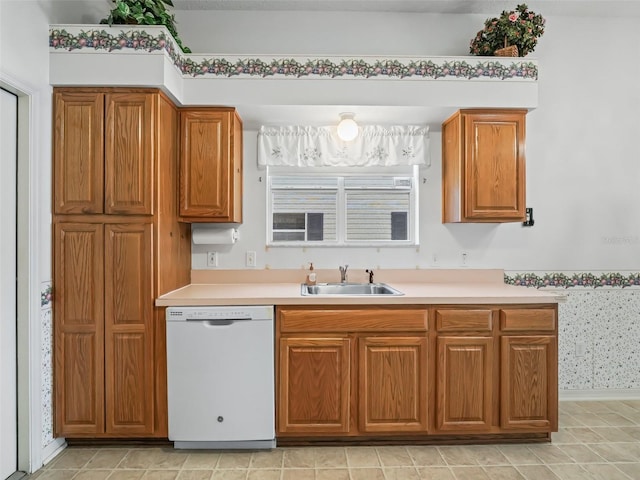 kitchen featuring dishwasher, light tile patterned flooring, and sink