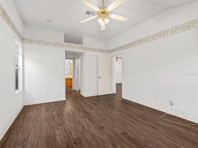 spare room featuring ceiling fan and dark wood-type flooring