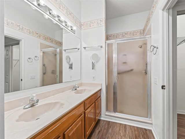 bathroom featuring vanity, hardwood / wood-style flooring, and an enclosed shower