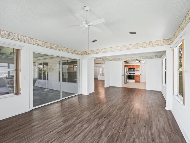 unfurnished living room featuring a textured ceiling, lofted ceiling, ceiling fan, and dark wood-type flooring