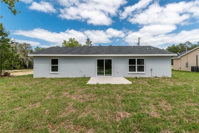 back of property with central AC, a yard, and a patio