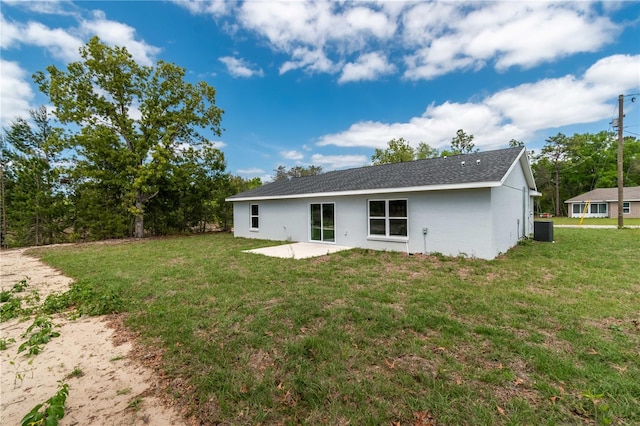 rear view of house with a yard, cooling unit, and a patio area