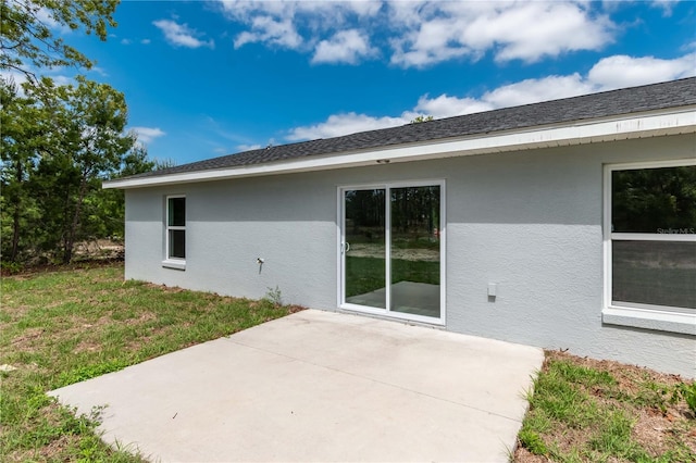 rear view of property with a yard and a patio