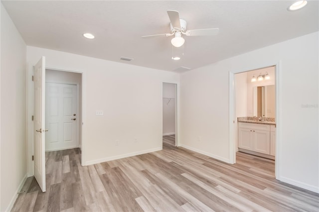 unfurnished room featuring ceiling fan and light wood-type flooring