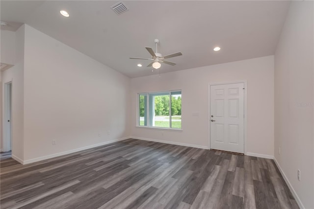 spare room featuring ceiling fan and dark wood-type flooring