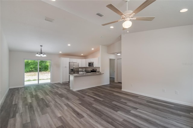 kitchen with appliances with stainless steel finishes, white cabinetry, hanging light fixtures, and dark wood-type flooring