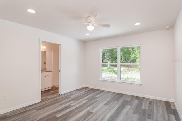 unfurnished room with light hardwood / wood-style flooring and ceiling fan