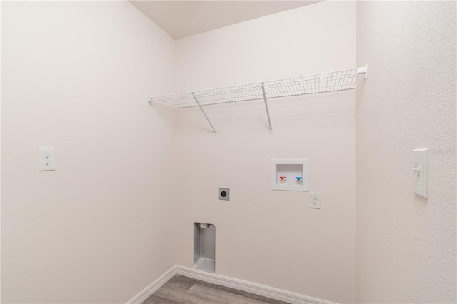 clothes washing area featuring hookup for an electric dryer, hardwood / wood-style floors, and washer hookup