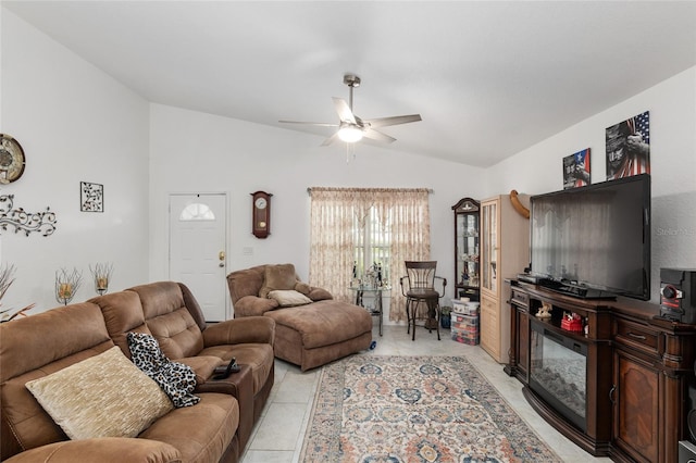 living room with ceiling fan, vaulted ceiling, and light tile patterned flooring