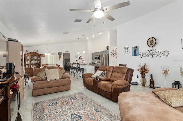 tiled living room with lofted ceiling and ceiling fan