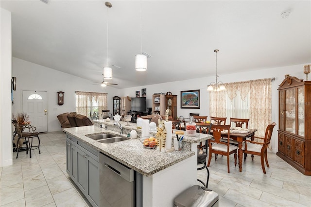 kitchen featuring gray cabinets, pendant lighting, stainless steel dishwasher, sink, and ceiling fan with notable chandelier