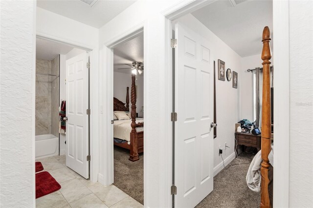 corridor with light colored carpet