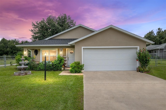 single story home featuring a yard and a garage