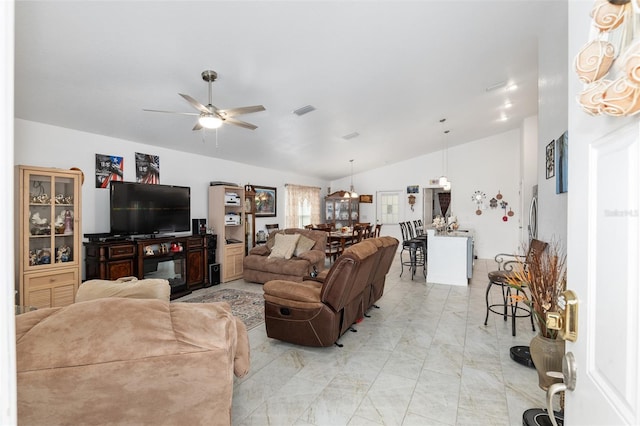 living room with ceiling fan and vaulted ceiling