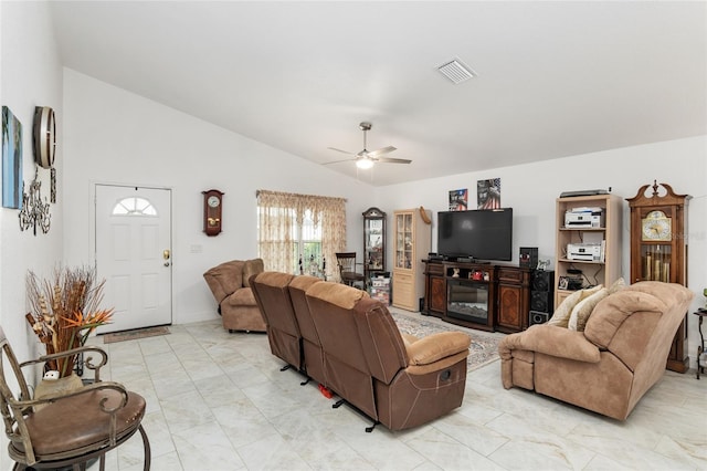 living room with ceiling fan and vaulted ceiling