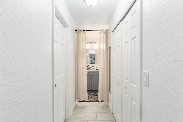 hall with a textured ceiling