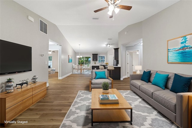 living room with hardwood / wood-style flooring, high vaulted ceiling, and ceiling fan