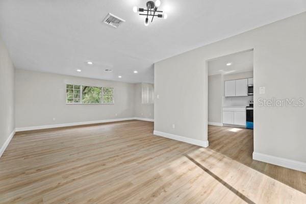 spare room with light hardwood / wood-style floors