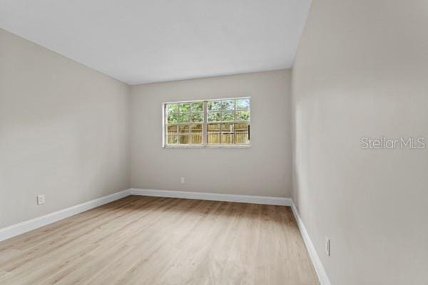 spare room featuring light wood-type flooring