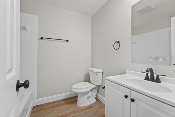 full bathroom featuring vanity, bathtub / shower combination, toilet, and hardwood / wood-style flooring