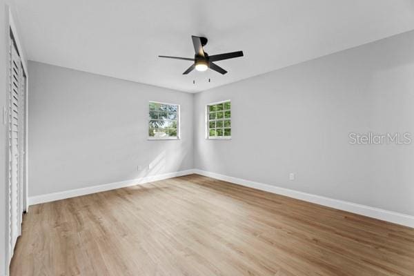 unfurnished bedroom with ceiling fan and light hardwood / wood-style flooring