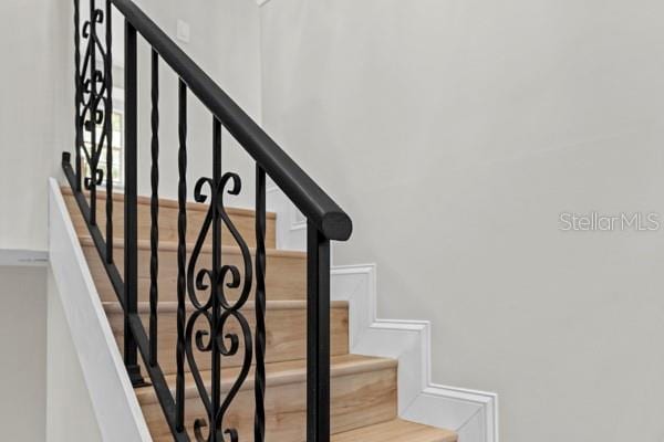 stairway with hardwood / wood-style flooring