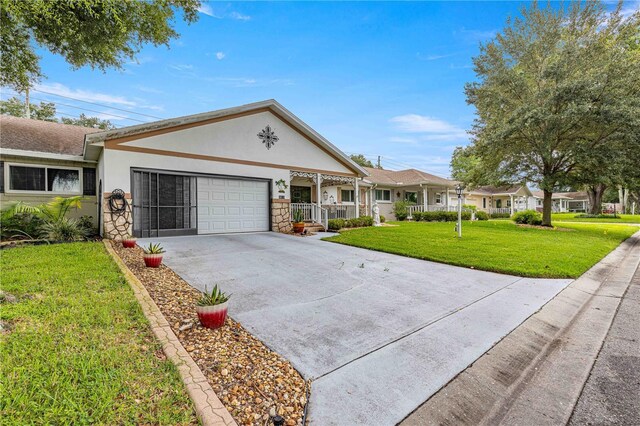 ranch-style home with a front lawn, a garage, and covered porch