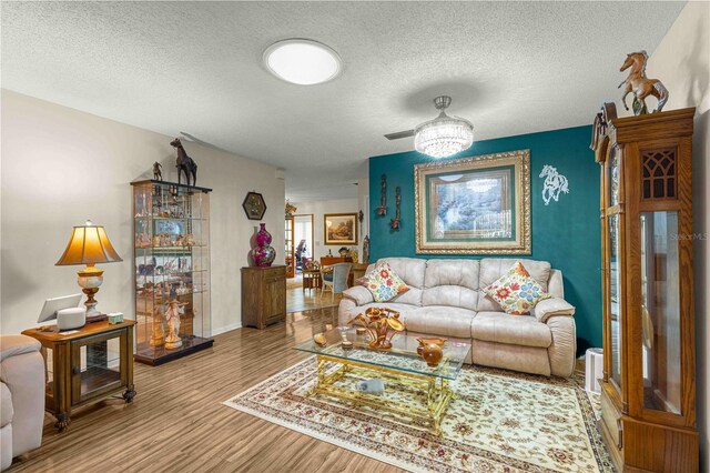 living room featuring a textured ceiling and light wood-type flooring