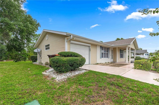 view of front of home with an attached garage, concrete driveway, and a front lawn