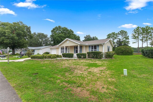 ranch-style house featuring a front lawn and a garage