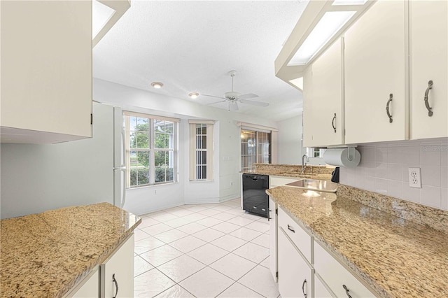 kitchen featuring black dishwasher, decorative backsplash, white cabinetry, ceiling fan, and light tile patterned flooring