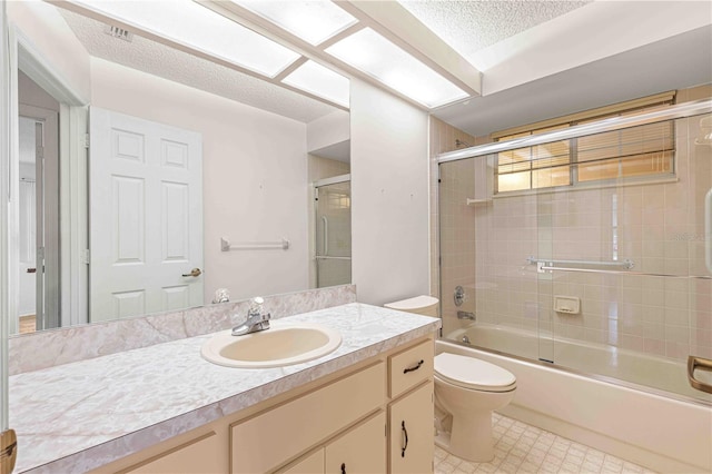 full bathroom with shower / bath combination with glass door, vanity, toilet, and a textured ceiling