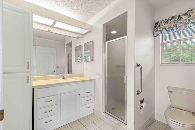 bathroom featuring vanity, toilet, a shower with shower door, and tile patterned flooring