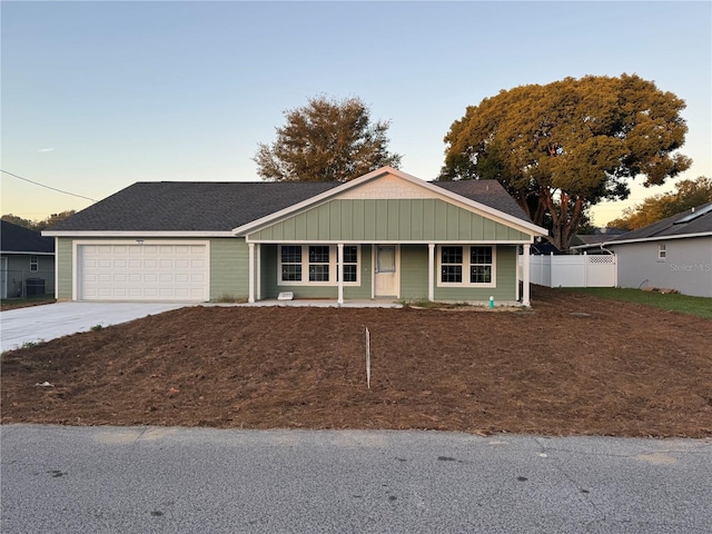 ranch-style home featuring a garage and a porch