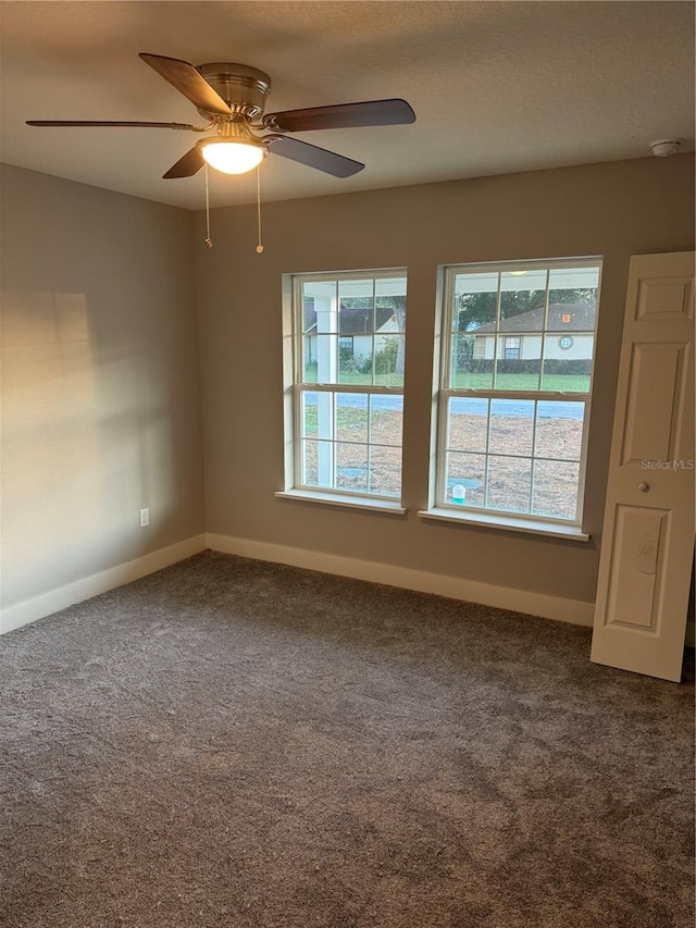 carpeted spare room with ceiling fan