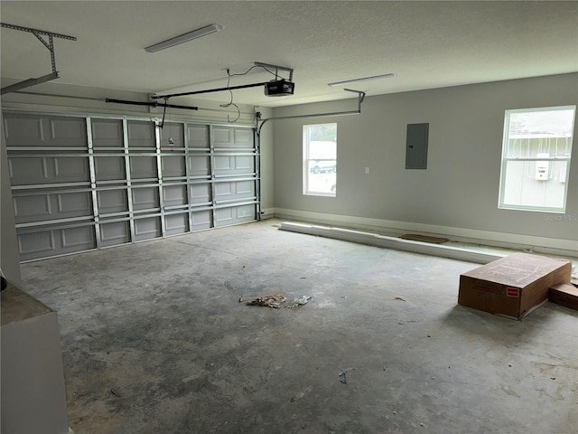 garage featuring electric panel and a garage door opener