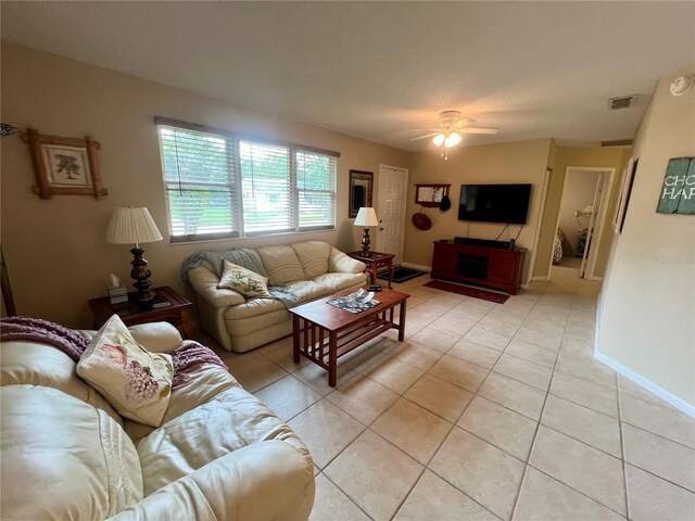 tiled living room featuring ceiling fan