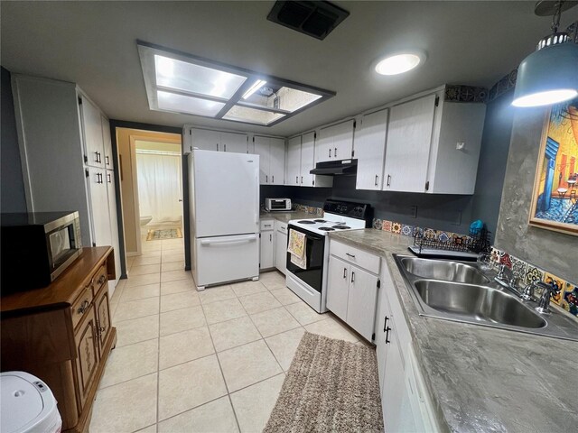 kitchen featuring light tile patterned floors, white cabinets, sink, and white appliances