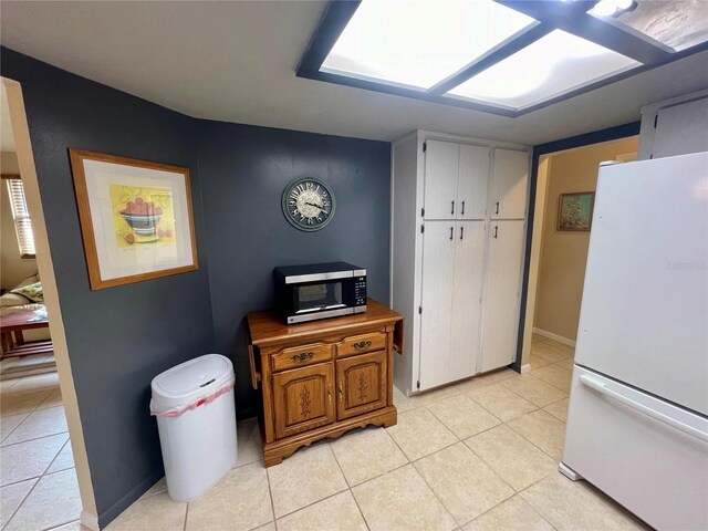 kitchen with white refrigerator and light tile patterned floors