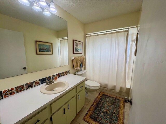 full bathroom featuring vanity, tile patterned flooring, a textured ceiling, shower / bathtub combination with curtain, and toilet